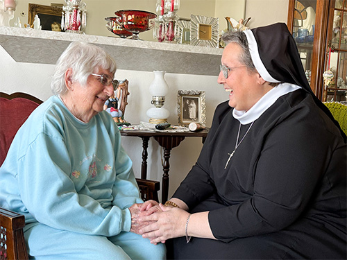 A sister visiting an elderly woman