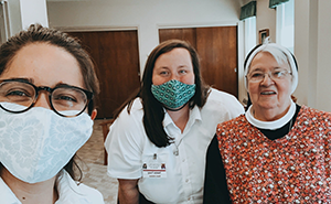 three sisters wearing masks
